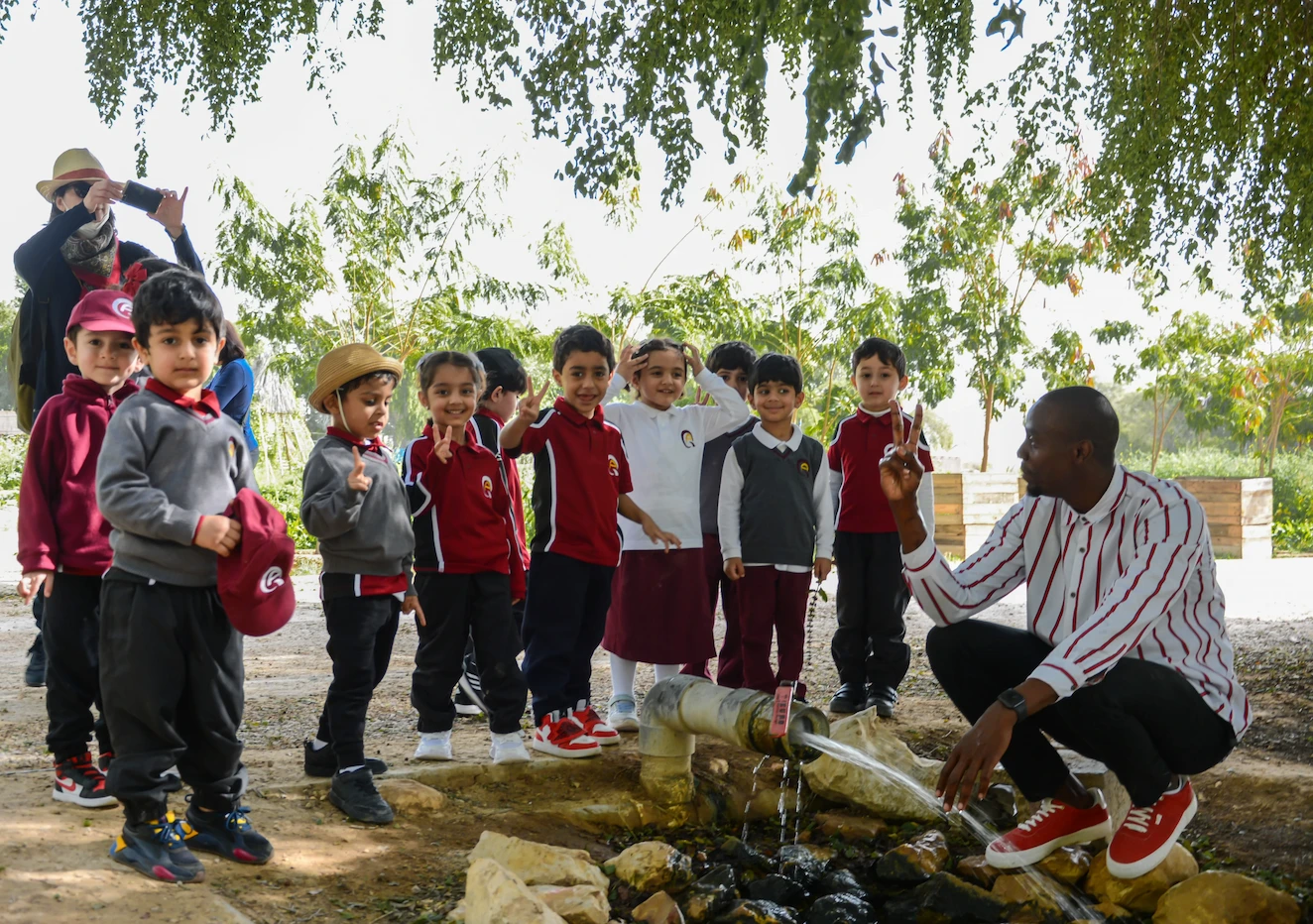 Children gardening at Heenat Salma Farm, engaging in planting vegetables.