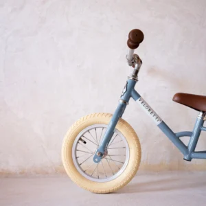 Adorable blue retro-style tricycle without pedals. Encourages balance, coordination, and physical activity for kids. Safe and stylish ride for little adventurers.